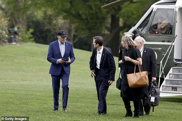 The White House is trying to calm staff fears after President Joe Biden's debate performance - above Biden with his deputy chief of staff Bruce Reed,  senior adviser Mike Donilon and Deputy Chief of Staff Annie Tomasini