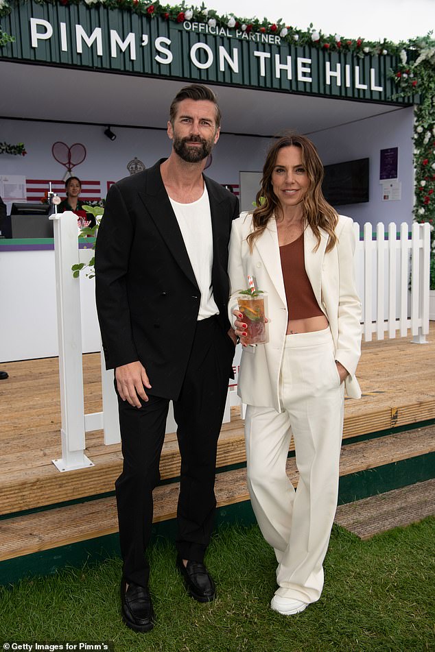 While Chris cut a dapper figure black suit, white T-shirt and dark shades as he put him arm around Mel