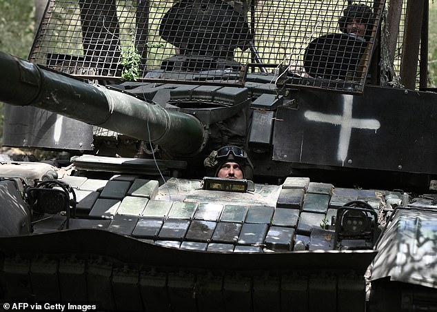 Ukrainian servicemen ride a T-72 tank in the Donetsk region in June amid the Russian invasion