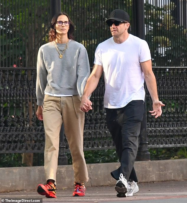 Jake (born Jacob) was wearing dark sunglasses, an all-black Boston Red Sox cap, a snug white T-shirt, black track pants, and grey New Balance sneakers