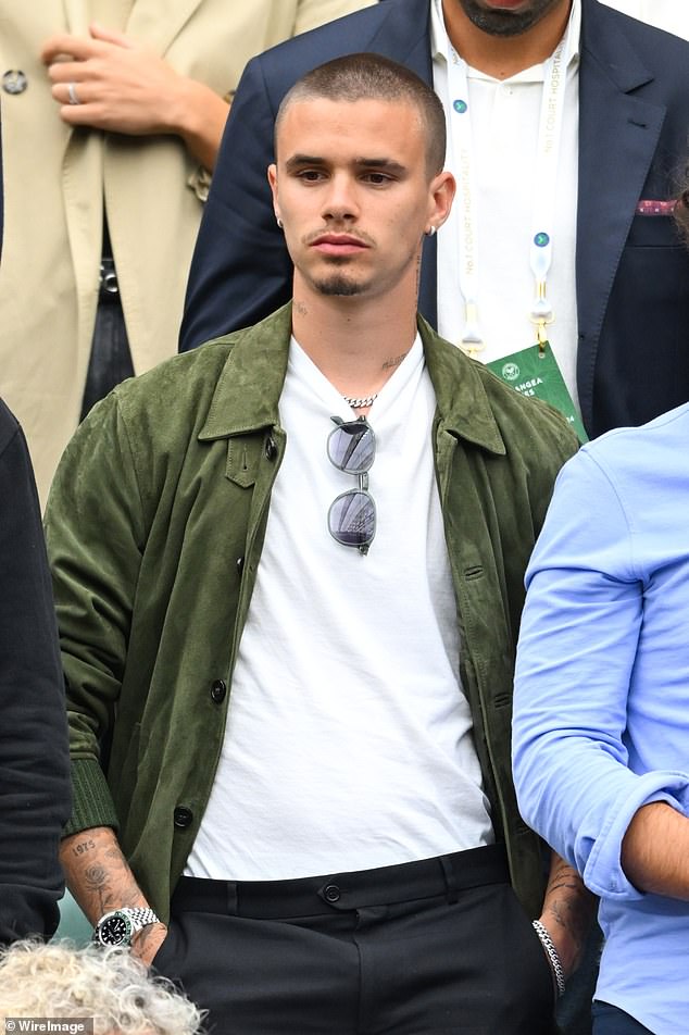 A heavily tattooed Romeo Beckham also opted for white as he watched Emma Raducanu breezing past Elise Mertens