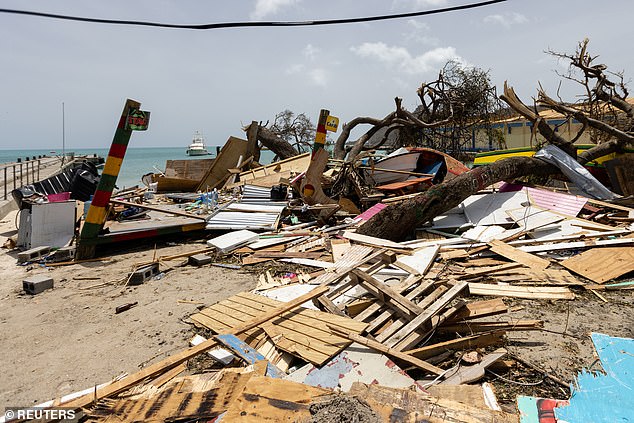 The storm has already made history as the strongest hurricane ever recorded in July, before it was downgraded from a Category 5 Tuesday. Scattered debris clutters the waterfront after Hurricane Beryl passed the island of Carriacou, Grenada is seen here