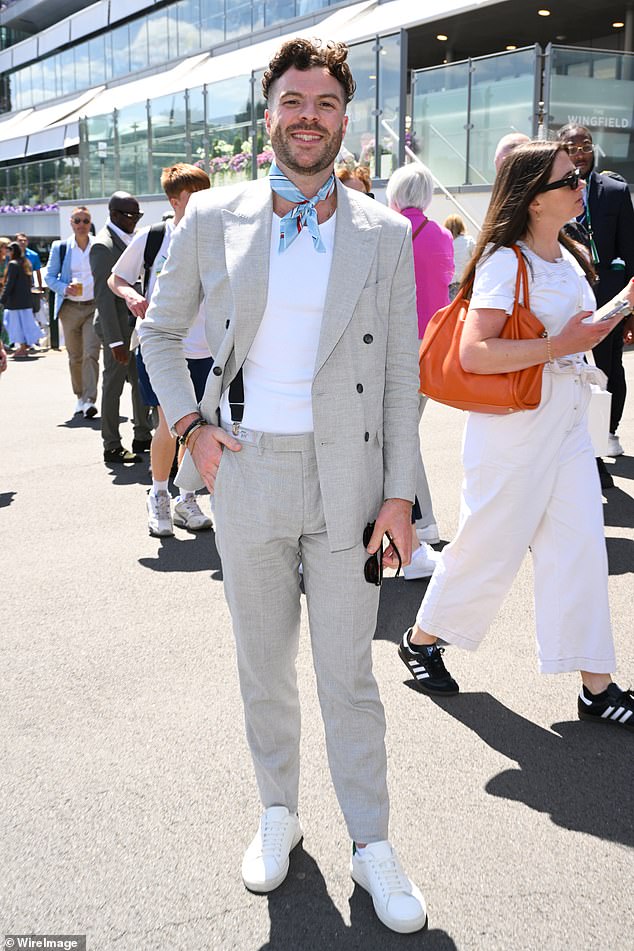 The radio star looked handsome in a light grey linen suit