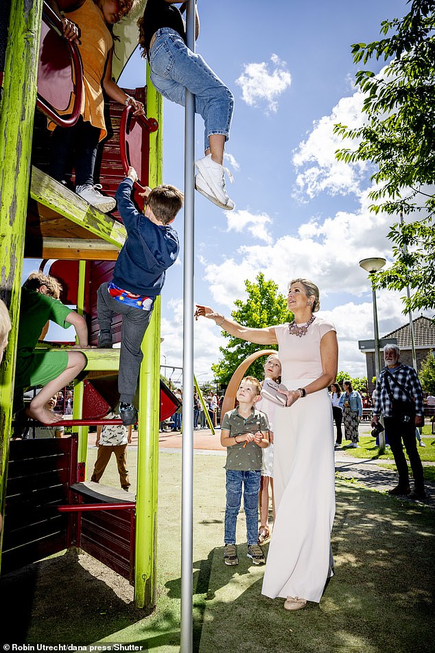 As a young girl shimmied down a pole in the playground, Queen Máxima appeared worried