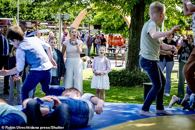 The mother-of-three cheered on children as they took part in activities and games in the playground