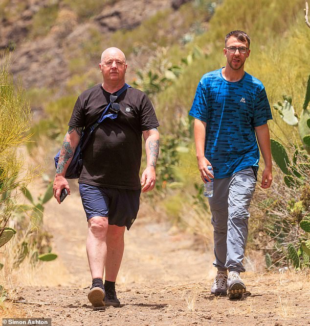 Jay's father Warren and brother Zak today hike through the mountain track where Jay's phone was last located