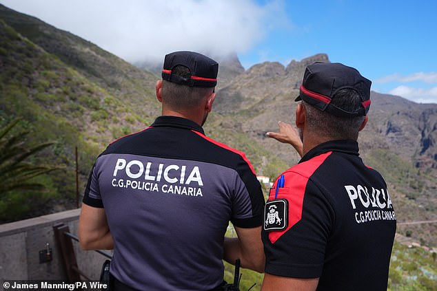 Police officers overlook the village of Masca, Tenerife on June 21