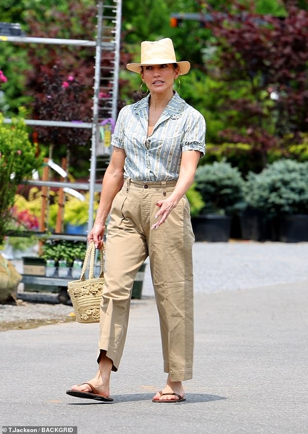 She cut a chic figure in a striped blouse, paired with high-waisted tan trousers and flip-flops as she marked July 4th on the East coast - while Affleck is in LA