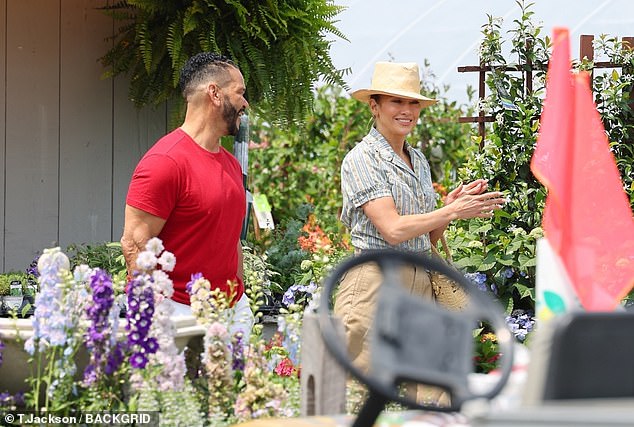 Lopez flashed a smile as she chatted with Medina at the shop