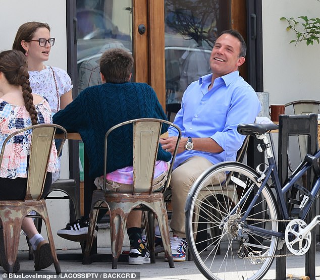 A smiling Affleck was seen in LA sporting his wedding ring while at lunch with his children Violet and Fin