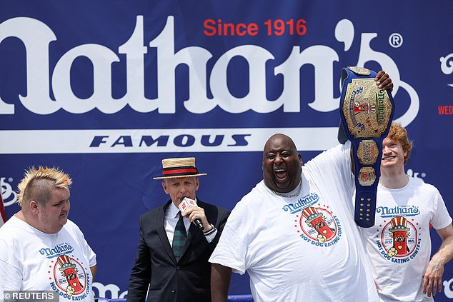 Booker, who chugs soda on YouTube, was given a belt for his win like wrestler do after a fight