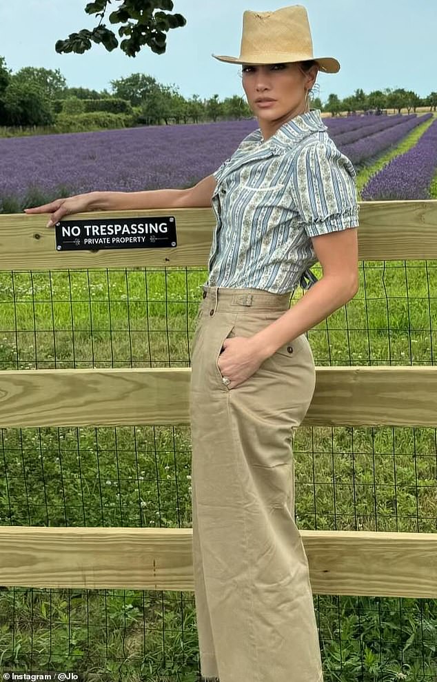 In one of her other poses, she stood against the fence, standing in a position that highlighted her toned frame as she pulled a smoldering supermodel stare