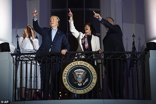 Later, during evening fireworks, Biden stood on the balcony with his family, Harris and her husband, Doug Emhoff, in a clear show of support