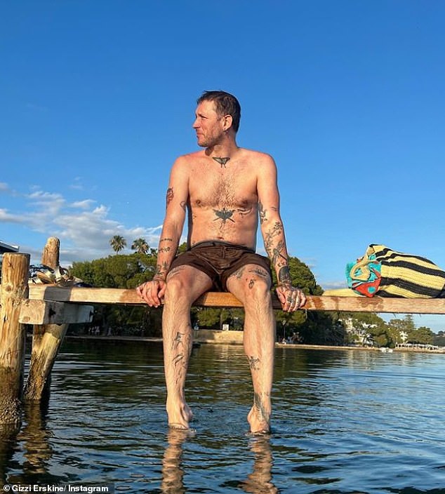 In another snap the brunette beauty posted a snap of her musician partner Matt sitting on a jetty in a pair of brown swimming shorts