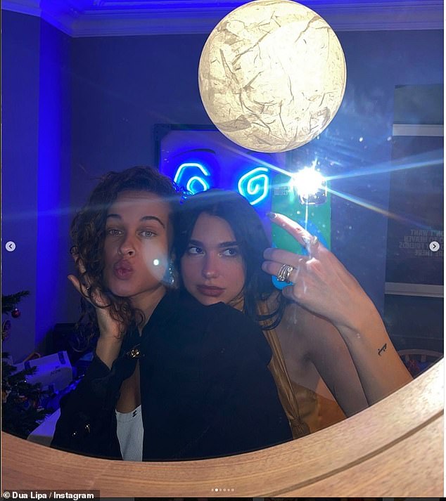 The singer posed for a snap in what appeared to be her living room with graphic neon lighting artwork and a wooden mirror