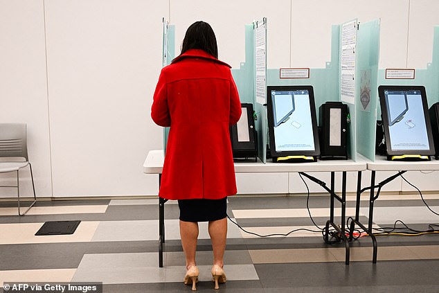 A voter prepares to cast a ballot on an electronic voting machine inside a vote center on Election Day during the Nevada 2024 presidential primary election. Carr expressed concerns over voting official's power over such voting machines and how tallies could be manipulated