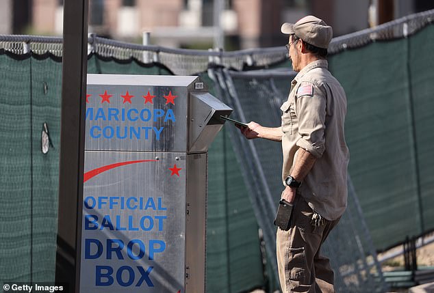 A voter drops off a mail-in ballot at a box in Maricopa County, Arizona, during the state's 2022 elections