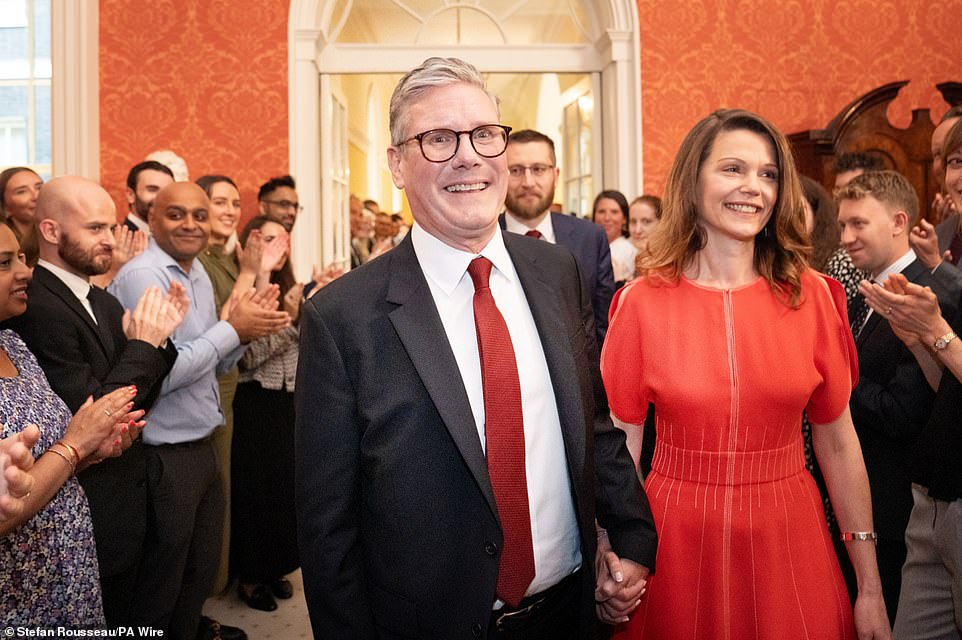 Sir Keir and wife Victoria were clapped into Downing Street yesterday (pictured), but Labour's victory is being dubbed a 'loveless landslide' and a 'super meh-jority'