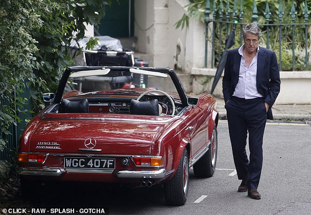 A brooding Cleaver stalks past his red Mercedes during filming