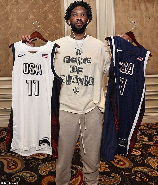 Sixers star Joel Embiid holding the USA Olympics jersey despite being linked to play for France