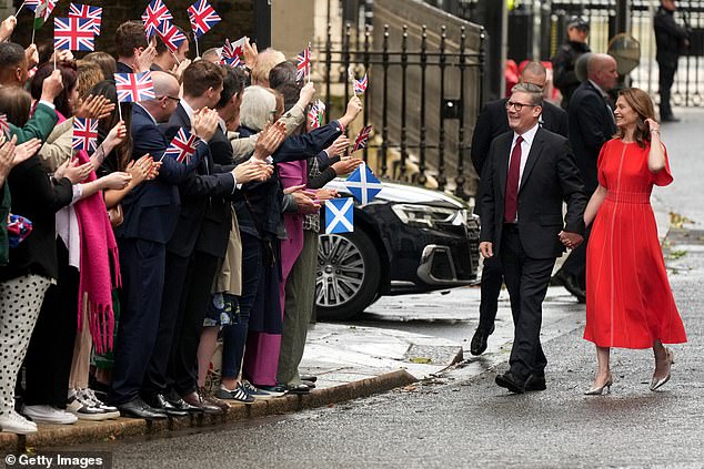 Sir Keir Starmer and wife Victoria, Lady Starmer greet supporters as he enters 10 Downing Street f