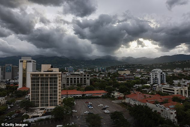 Storm clouds hover over the mountains as people make last-minute preparations for the arrival of Hurricane Beryl on July 03, 2024 in Kingston, Jamaica