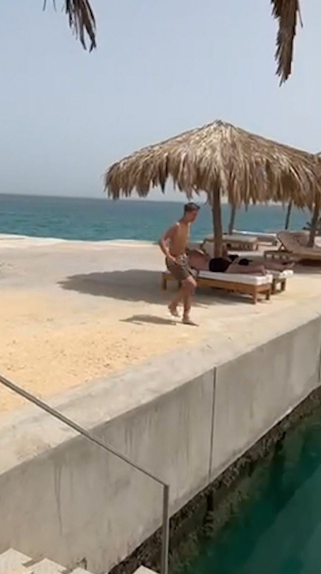 Video footage from his holiday in Egypt in September shows him laughing and doing the same move off the side of a jetty