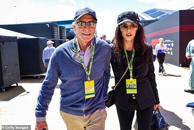 Catherine Zeta-Jones cosied up to her husband Michael Douglas as they enjoyed a day out at the star-studded British Grand Prix at Silverstone on Sunday