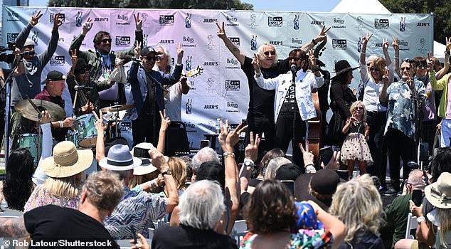 Joe was seen joining Ringo on the stage, as he spoke to the gathered crowd while encouraging everyone to put up double peace signs during the traditional 'Peace and Love' exclamation