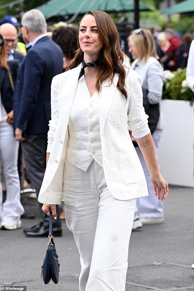 The Skins actress, 32, nailed summer style in a white linen suit and matching waistcoat as she strutted around the grounds