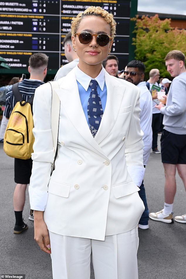 She added to her look with a pair of stylish sunglasses as she posed for snaps at the tennis tournament