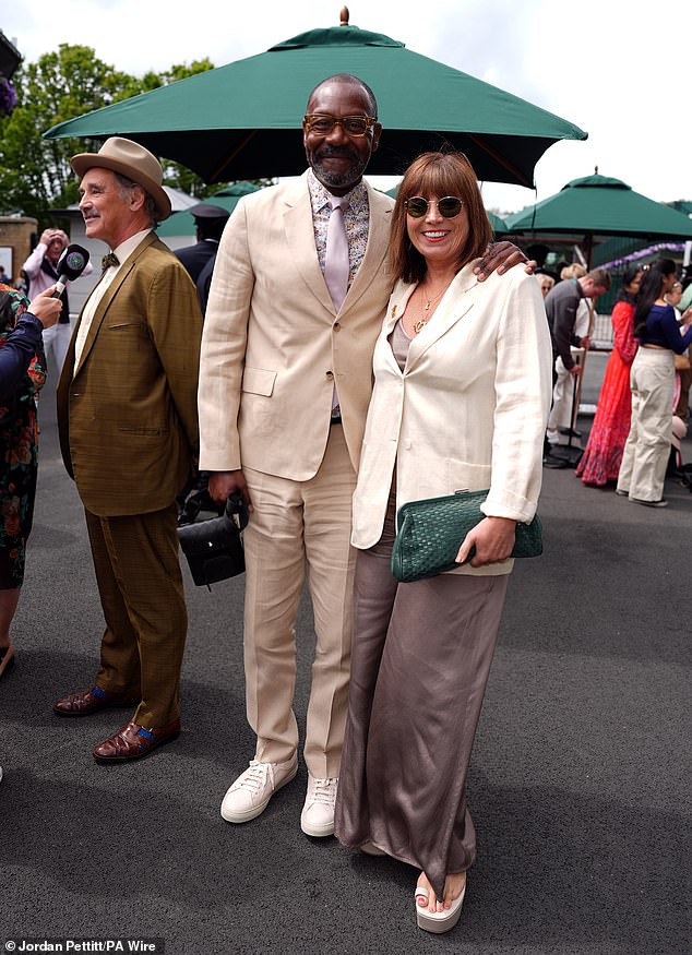 While Lisa complemented him in neutrals, wearing a brown satin dress and cream blazer with round sunglasses