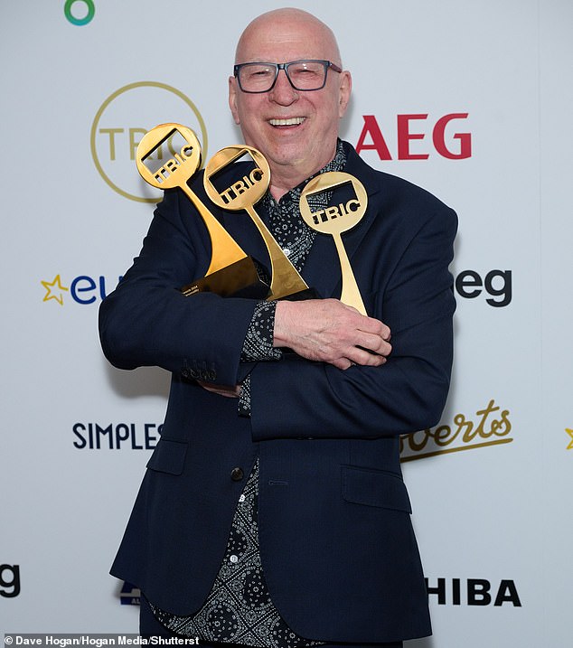 Ken Bruce pictured with three TRIC awards after a successful night on June 25. The DJ has said his former employer Radio 2's urge to 'think of itself as being cool' is damaging the station