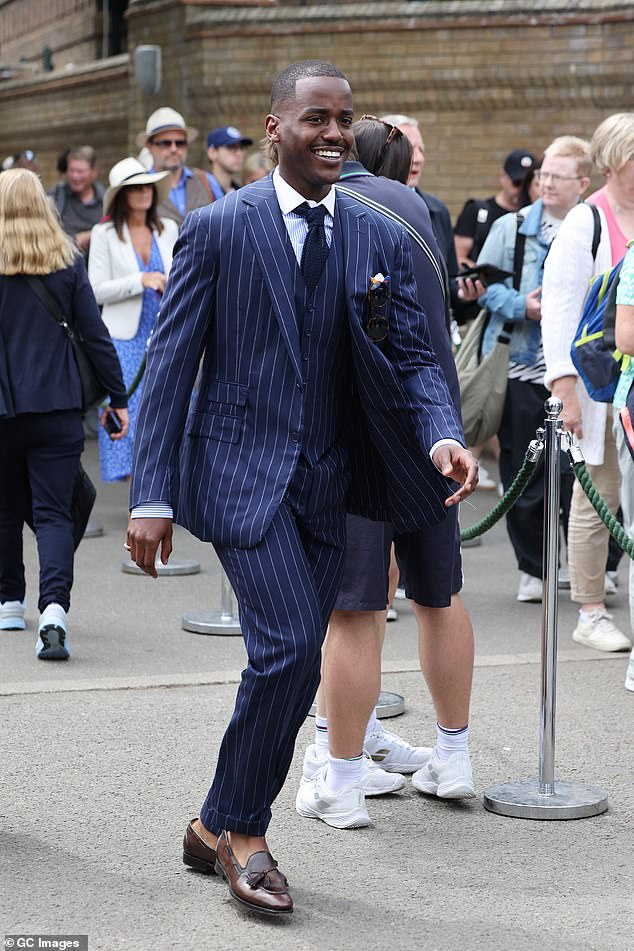 Doctor Who star Ncuti Gatwa looked typically handsome in a navy pinstripe suit, with a matching waistcoat and quirky knitted tie