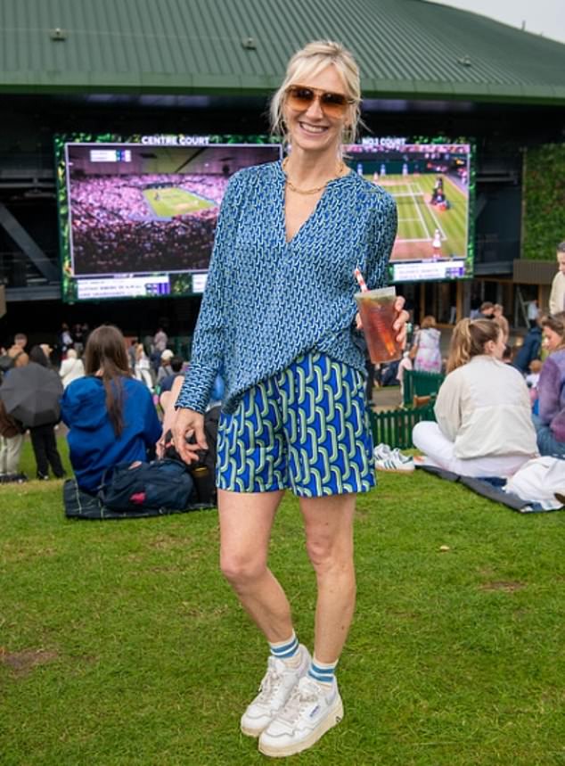 Jo Whiley put on a leggy display in a blue patterned co-ord as she sipped on a glass of Pimms while watching the tennis