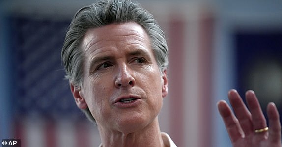 FILE - California Gov. Gavin Newsom greets people, July 8, 2024, near the Common Man Roadside Market and Deli, in Hooksett, N.H. (AP Photo/Steven Senne, File)