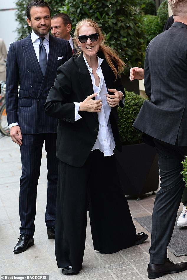 Céline added some loafers, topping her looked off with a pair of sunglasses and a huge designer handbag