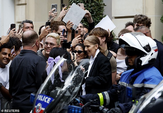 The Canadian singer who is battling the incurable stiff-person syndrome , happily posed for photos with fans outside her exclusive hotel