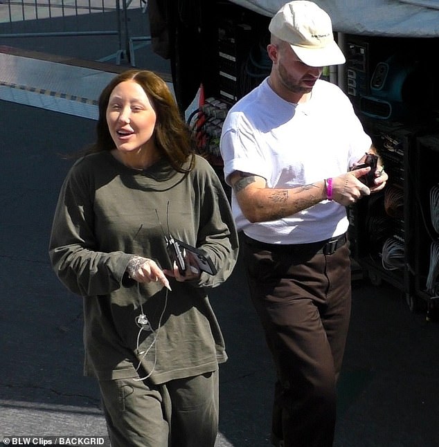 The 24-year-old singer was pictured walking with a friend near the stage before rehearsing. It came after her dad Billy Ray Cyrus, 62, was heard calling her sister Miley Cyrus a 'skank' and a 'liar' in an expletive-filled rant obtained exclusively by DailyMail.com