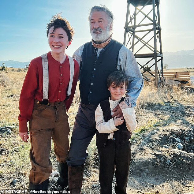 Alec Baldwin, 66, was praised by Brett Ashley McMillan, the mother of two child actors working on his film Rust. Baldwin pictured with costars Patrick Scott McDermott (L) and McMillan's son Easton on the set of the movie, which resumed production in 2023 in Montana after the fatal shooting of cinematographer Halyna Hutchins in October of 2021