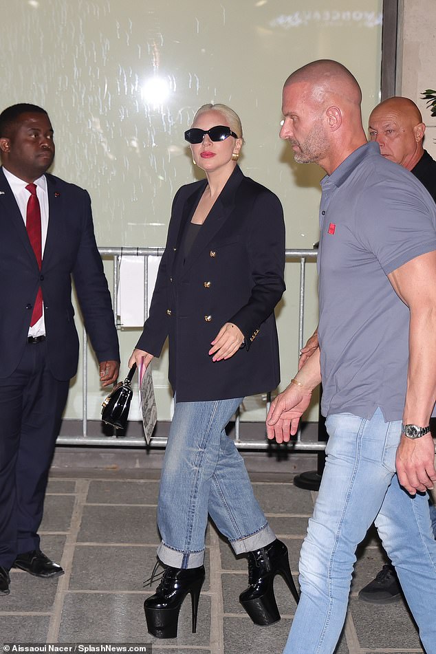 Gaga, who wore a light palette of makeup, added to her outfit with a black handbag