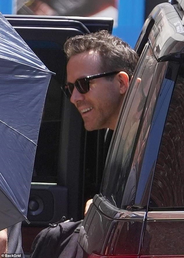 Ryan looked equally cheerful as he smiled while climbing out of his car also wearing a pair of dark sunglasses before heading in for a day of filming with his Deadpool & Wolverine co-star