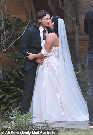 The newlyweds proved there was an initial spark as they shared a kiss while a cameraman snapped shots of them on their wedding day