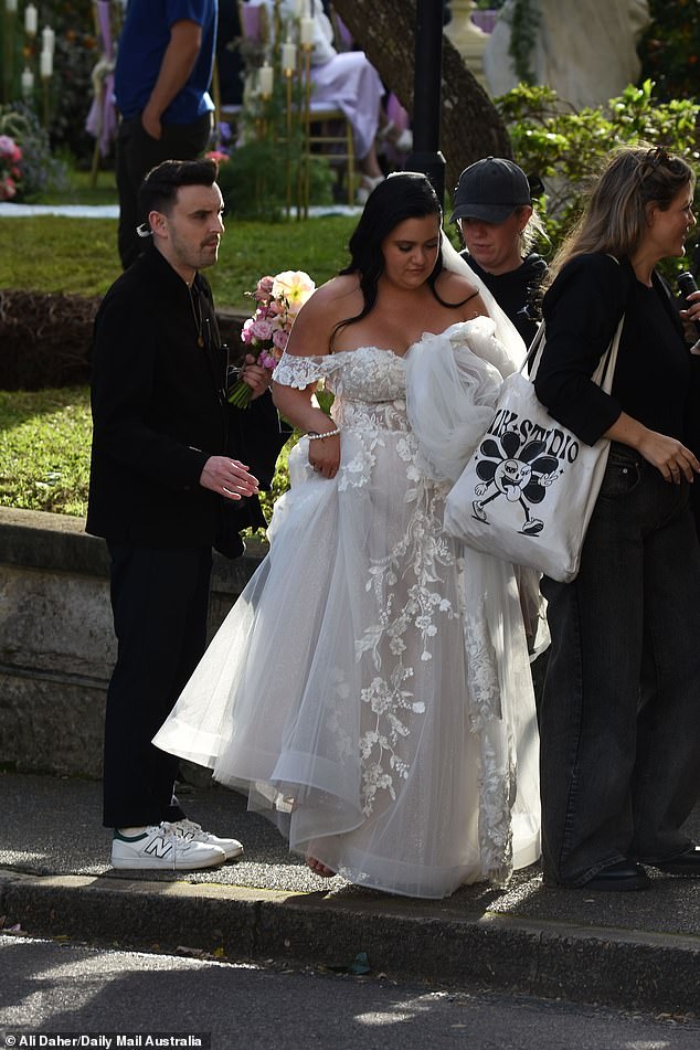 Ashleigh styled her glossy raven tresses in a half-up half-down style and fixed a veil on top of her head to complete her elegant bridal ensemble