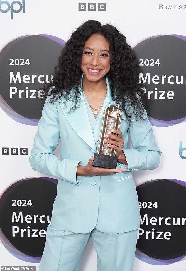 Corinne Bailey Rae holding the shortlist trophy for her album Black Rainbows