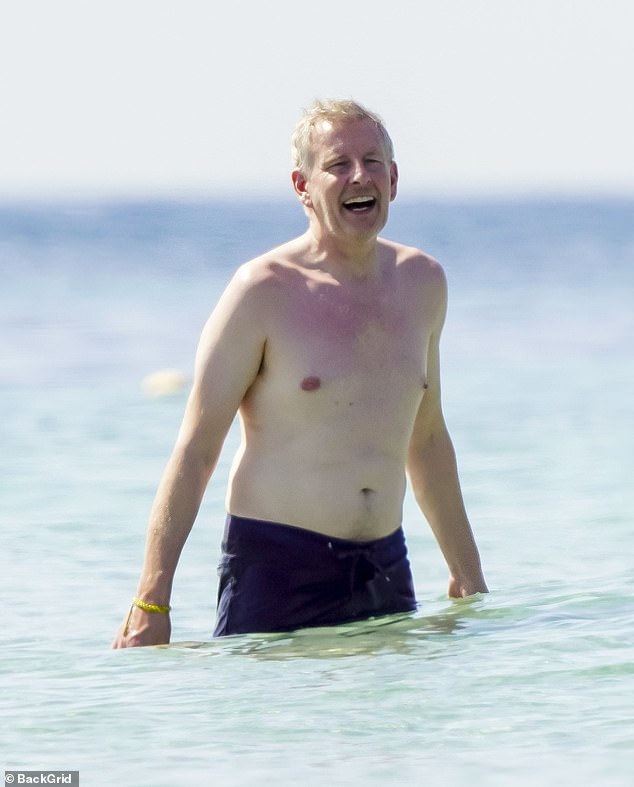 Meanwhile her husband Patrick showed off his shirtless physique as he headed into the ocean for a swim