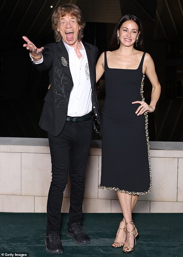 Sir Mick Jagger , 80, put on an animated display with his partner Melanie Hamrick , 37, at Louis Vuitton's Prelude To The Olympics 2024 in Paris on Thursday