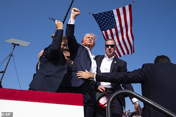 Republican presidential candidate former President Donald Trump is surrounded by U.S. Secret Service agents at a campaign rally, Saturday, July 13, 2024, in Butler, Pa. (AP Photo/Evan Vucci)