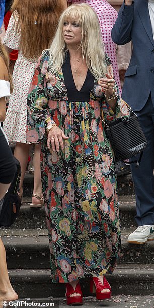 The mother-of-the-groom opted for a floral maxi dress and eye catching red platforms