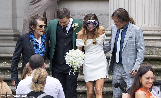 The rock and roll legends beamed as they posed with the newlyweds for snaps